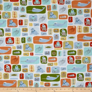 May include: A white fabric with a repeating pattern of sea creatures and nautical objects. The pattern includes narwhals, walruses, crabs, jellyfish, anchors, and steering wheels. The background is a light blue colour.