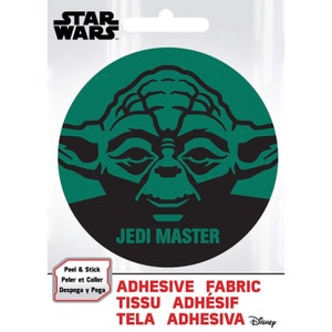May include: A green and black round sticker featuring a black silhouette of Yoda, a character from Star Wars, with the text "Jedi Master". The sticker is labeled "Peel & Stick" and "Adhesive Fabric".