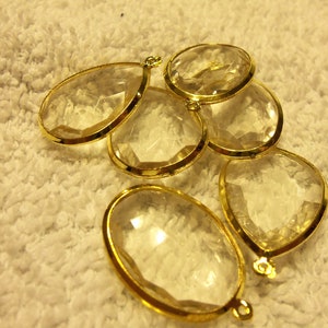 Drop, Blue Moon Beads, acrylic and gold-finished steel, clear, assorted. Pkg of 6.