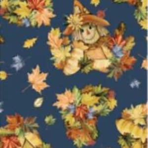 May include: A dark blue fabric featuring a repeating pattern of scarecrows wearing tan hats and straw-colored clothing, surrounded by clusters of vibrant autumn leaves in shades of orange, yellow, red, and green, scattered across the dark background.