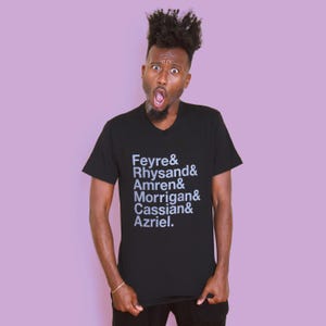 May include: A black t-shirt with a white print that reads "Feyre & Rhysand & Amren & Morrigan & Cassian & Azriel."