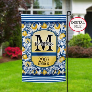 May include: A blue and white garden flag with a lemon pattern. The flag has a gold banner with the letter "M", the text "The Millers", the number "2907", and the text "Beverly Rd".