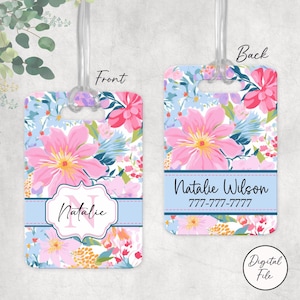 May include: Floral luggage tag with a clear strap. The front features a pink flower design with the name "Natalie" and the initial "N". The back has the name "Natalie Wilson" and a phone number.