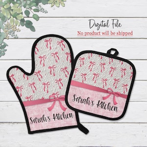 May include: A set of two pink and white oven mitts with a pink ribbon and the text "Sarah's Kitchen".