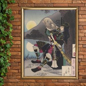 Puede incluir: Una impresión japonesa vintage en madera que representa a un guerrero samurái con un atuendo azul oscuro y verde, sosteniendo una concha de caracol en la boca, con una luna y montañas en el fondo. La impresión está enmarcada en un marco dorado.