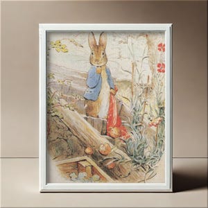 May include: Framed print depicting a rabbit in a blue jacket and red sack, set against a backdrop of a wooden fence and foliage. The illustration, in a classic children's book style, features soft colours and detailed botanical elements. The artwork is presented in a white frame.