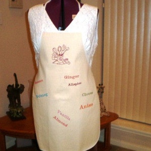 Adult apron embroidered with kitchen utensils and baking spices. Vanilla..nutmeg..anise..clover and cinnamon.