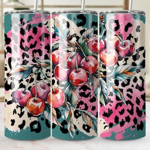 May include: A stainless steel tumbler with a vibrant design. The tumbler features a teal, pink, and black leopard print background. A watercolour illustration of cherries and leaves is centered on the tumbler. The tumbler has a silver straw.