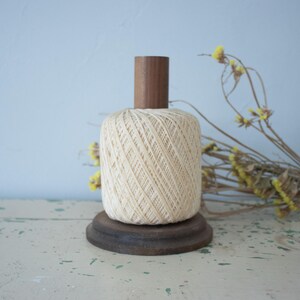 May include: A set of three ceramic vases in varying heights. The vases are white with a textured, ridged design. The tallest vase is approximately 10 inches tall, the medium vase is 8 inches, and the smallest is 6 inches.