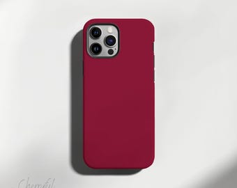May include: A red phone case for an iPhone with a camera cutout.