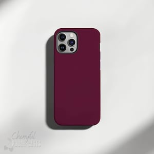 May include: A burgundy phone case for an iPhone with a camera cutout.
