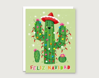May include: A festive greeting card featuring a cartoon cactus wearing a red sombrero and strung with Christmas lights and chili pepper garland. The words "Feliz Navidad" are printed in colorful letters at the bottom, set against a light green background.