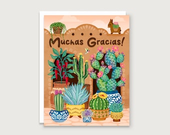May include: Greeting card with a colorful illustration of various cacti and succulents in decorative pots. The card features the text "Muchas Gracias!" in a brown, stylized font. A small donkey and a hanging basket of greenery are also depicted.