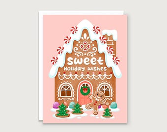 May include: A holiday greeting card featuring a gingerbread house with white icing, peppermints, and the text "sweet Holiday wishes." A gingerbread man and Christmas trees are also depicted on the pink card.