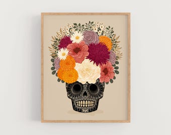 May include: A black sugar skull with intricate designs is adorned with a colorful bouquet of flowers, including orange marigolds, pink and white roses, and burgundy chrysanthemums.