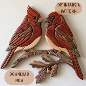 May include: Two wooden cardinal birds perched on a branch with leaves and an acorn. The birds are made of various shades of brown wood, with red and tan accents. The text "DIY INTARSIA PATTERN" and "DOWNLOAD NOW" are visible.
