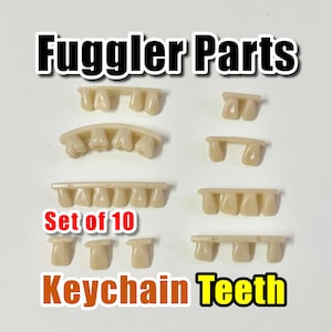 May include: A collection of 10 off-white plastic teeth for keychains, with the text "Fuggler Parts" and "Keychain Teeth". The teeth come in different sizes and shapes, ideal for crafting or customising projects.