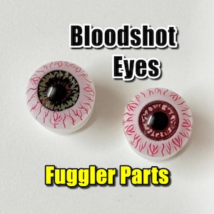 May include: Two round, bloodshot eyes with a white base, red veins, and a dark center. The text "Bloodshot Eyes" and "Fuggler Parts" are displayed above and below the eyes.