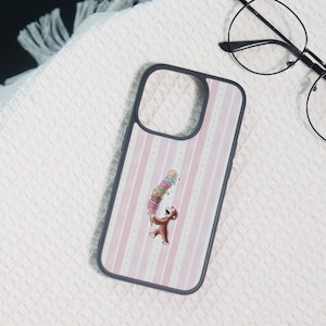 May include: A dark-rimmed phone case featuring a light pink and white vertical striped background. Centered on the case is a brown monkey character holding a tall, multi-coloured stack of ice cream scoops that is beginning to melt.