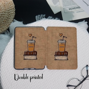 May include: A double-printed tablet case featuring a coffee cup with a straw and a heart above it, sitting on a stack of books. The case has a brown background with the word "COFFEE" on the cup. The text "Double printed" is at the bottom.