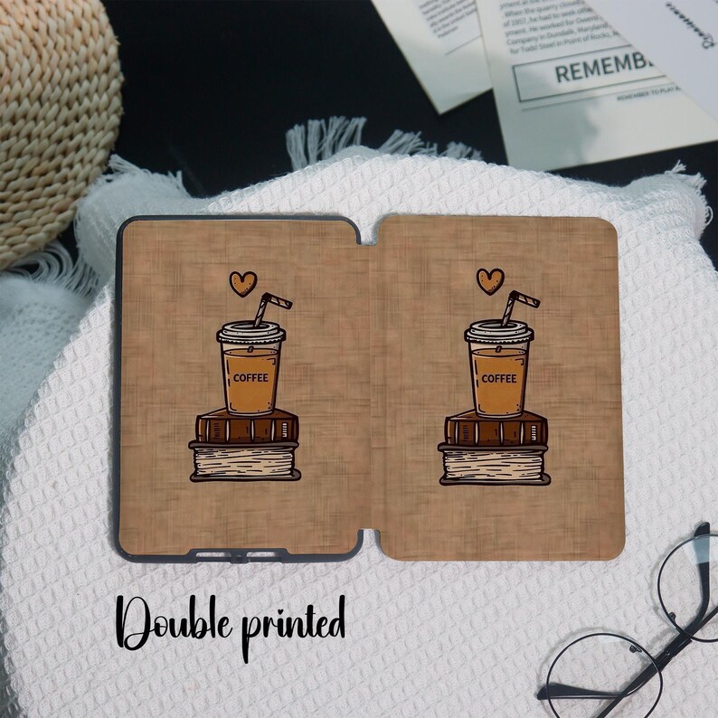 May include: A double-printed tablet case featuring a coffee cup with a straw and a heart above it, sitting on a stack of books. The case has a brown background with the word "COFFEE" on the cup. The text "Double printed" is at the bottom.