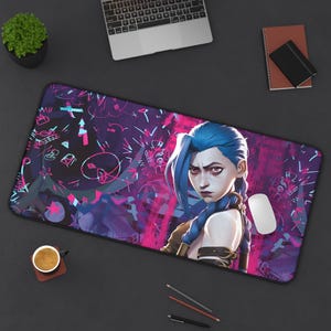 May include: A purple and pink gaming mouse mat featuring a graphic of a blue-haired anime character wearing a pink and white outfit. The background is a dark purple with pink and white graffiti.