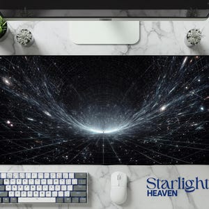 May include: A rectangular desk mat featuring a deep space design with a black background, a white grid pattern, and streaks of light converging toward a central point. The text Starlight HEAVEN is printed in blue in the bottom right corner.