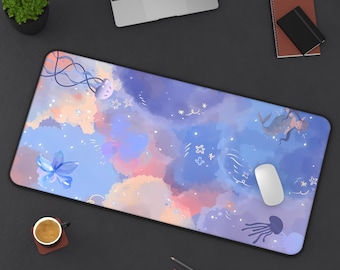 May include: A large rectangular mouse pad with a dreamy watercolor design. The pad features a celestial theme with clouds in shades of blue, purple, and pink, along with whimsical illustrations of jellyfish, stars, and a mermaid. A white mouse sits on the pad.