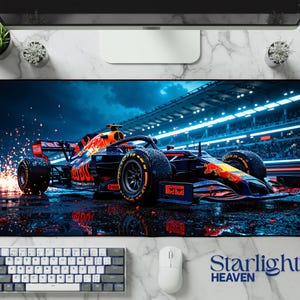 May include: A large rectangular mousepad featuring a Formula 1 race car in motion. The car is primarily red and blue, with the Red Bull logo prominently displayed. The background depicts a race track with stadium lights and a wet surface. The text "Starlight Heaven" is at the bottom.