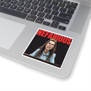 May include: A sticker featuring a cartoon illustration of a woman with an angry expression, wearing a crown. The word "NEFARIOUS" is printed in red above the woman's head against a black background. The sticker is placed on a laptop.