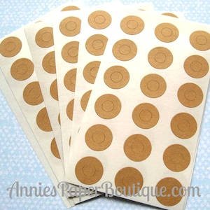 May include: Five sheets of white paper with brown circle stickers. Each sheet has 30 stickers with a circle cut out of the center.
