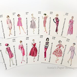 May include: A collection of vintage sewing patterns for dresses and suits. The patterns are printed on white cards with pink and black text. The patterns are numbered 1206, 1207, 1208, 1209, 1210, 1211, 1212, 1213, 1214, 1215, 1216, and 1217. Each pattern is priced at 50 cents.