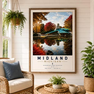 May include: A framed wall art print featuring a landscape photograph of a building with a teal roof surrounded by autumn trees reflecting in a pond. The text reads MIDLAND MICHIGAN, MICHIGAN MAIN STREET COLLECTION, NO. 02, DOW STUDIO, MIDLAND, MI.