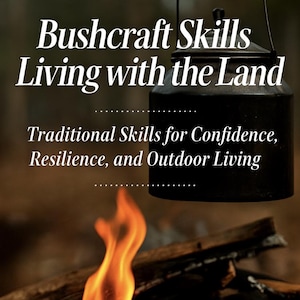 May include: Image of a book cover with the title "Bushcraft Skills Living with the Land." The cover features a campfire with flames, firewood, and a black pot. The text reads "Traditional Skills for Confidence, Resilience, and Outdoor Living."