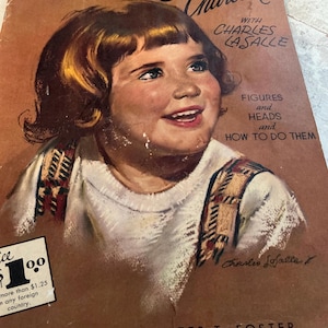 May include: Vintage book cover titled "Drawing in Charcoal" featuring a smiling child's portrait. The cover is a sepia tone with text including "Figures and Heads and How to Do Them" and the author's name, Charles LaSalle.