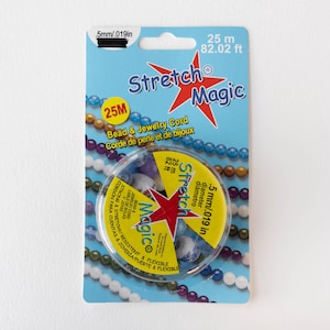 May include: A package of Stretch Magic bead and jewellery cord. The package is light blue with the words "Stretch Magic" in red and white. The cord is .5mm/.019in in diameter and 25 metres/82.02 feet long. The package also includes the words "Bead & Jewellery Cord" in English and French.