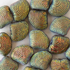 May include: A collection of iridescent green and gold glass beads with a textured, shell-like design. The beads are irregularly shaped and have a slightly rounded, oval-like form.
