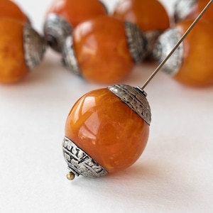 May include: A set of three ceramic mugs with a speckled, matte finish. The mugs are in shades of cream, light gray, and dark gray. Each mug has a simple, minimalist design and a rounded handle.