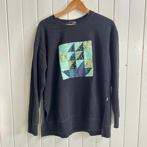 May include: A handmade wooden sign displaying the word "Welcome" in a playful font. The sign is painted white with a distressed finish, and includes a small floral decoration. Ideal for a front door or hallway.