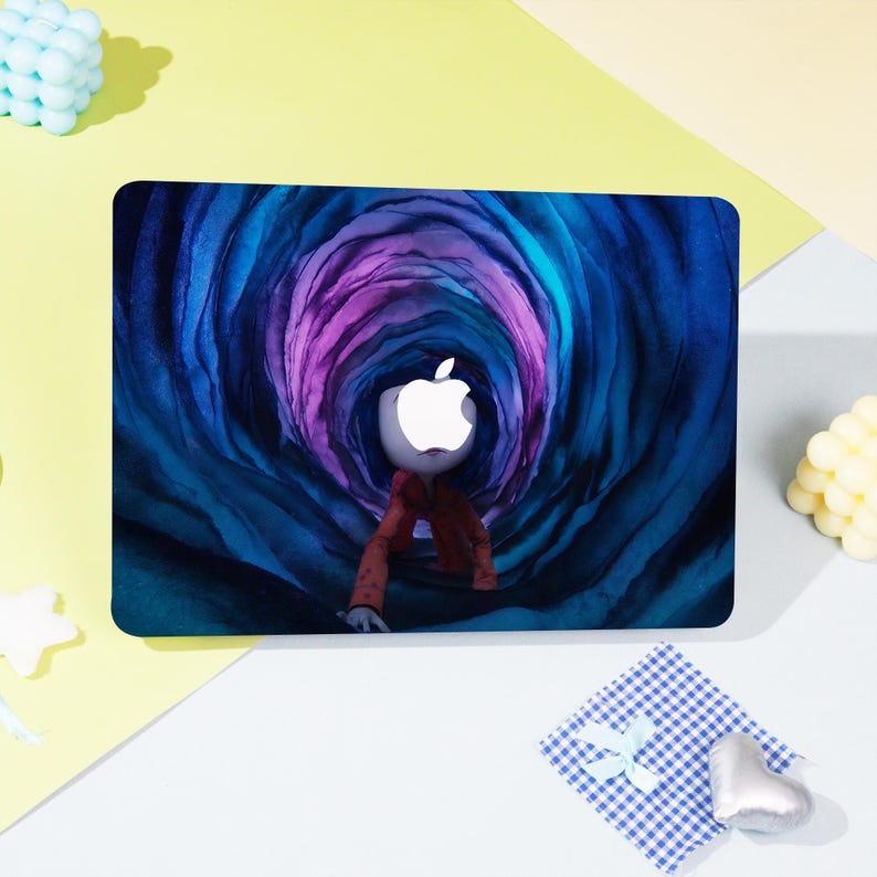 May include: A laptop skin featuring a stylized illustration of a figure with an Apple logo head, wearing a red jacket, in a blue and purple tunnel. The design is on a black rectangular surface.