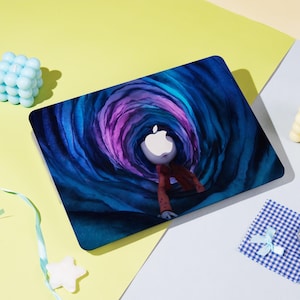 May include: Laptop skin featuring a surreal illustration of an Apple logo figure in a swirling tunnel of blue and purple hues. The design is printed on a rectangular surface, with a matte finish.