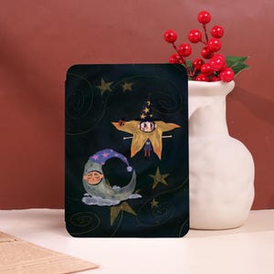 May include: A rectangular art print featuring a whimsical illustration of a star-shaped figure wearing a witch hat, a crescent moon with a sleeping face, and stars on a dark background. The artwork has a fairytale theme with a touch of fantasy.