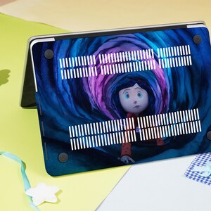 May include: A laptop case featuring a colorful illustration of a character from the animated film, Coraline. The design showcases a swirling tunnel of blue and purple hues, with the character in the center. The case has white ventilation stripes.