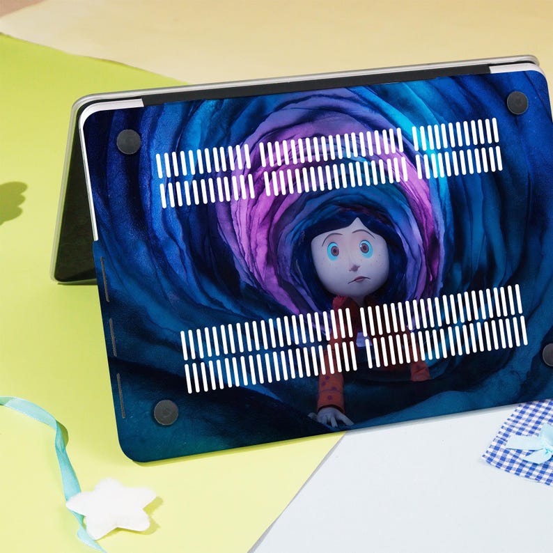 May include: A laptop case featuring a colorful illustration of a character from the animated film, Coraline. The design showcases a swirling tunnel of blue and purple hues, with the character in the center. The case has white ventilation stripes.