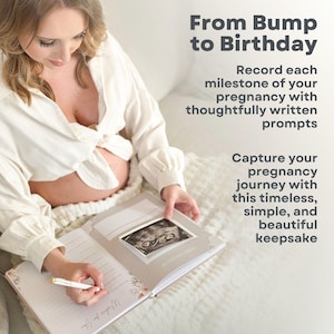 May include: A pregnant person is writing in a pregnancy journal with a white pen. The journal has a grey cover with the text "From Bump to Birthday" and a photo of an ultrasound image. The text on the page reads "We welcome you".