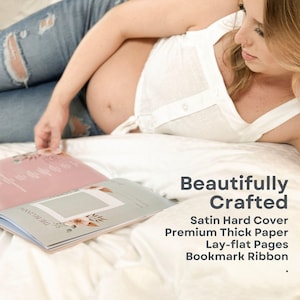 May include: A pregnant person is reading a book with a satin hard cover, thick paper, lay-flat pages, and a bookmark ribbon. The book has a floral design and the text "The Beginning" on the cover.