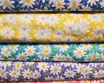 May include: Four different fabric swatches with a white daisy pattern on a blue, yellow, light blue, and purple background. The fabric swatches are stacked on top of each other.