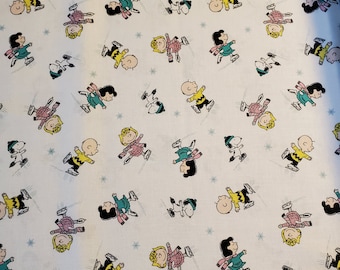 May include: White fabric with a repeating pattern of cartoon characters ice skating. The characters are wearing colorful hats, scarves, and sweaters. The background is white with a snowflake pattern.