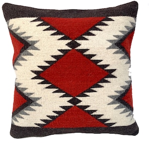 May include: A red, white, and black geometric patterned throw pillow. The pillow is made of a soft, woven fabric.