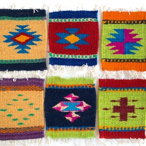 May include: Six colorful woven coasters with geometric patterns. The coasters are made of wool and have a fringe border. The patterns include a diamond shape with a star inside, a cross, and a diamond shape with a star inside.